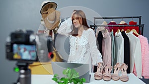 Stressed woman selling clothes and accessories online by camera live streaming, business online e-commerce at home