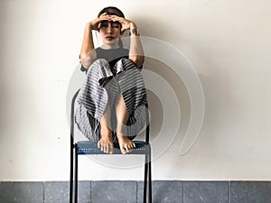 Stressed woman sitting with a high knee on chair ,with upset and unhappy feeling,depressive disorder syndrome