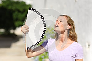 Stressed woman suffering heatstroke on summer photo
