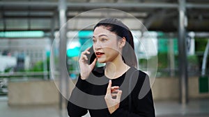 Stressed woman talking with mobile phone about her business problem in city