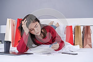 stressed woman using tablet and having problem for online shopping in bedroom