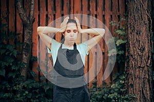 Stressed Woman Wearing an Apron Feeling Overwhelmed