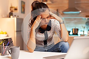 Stressed woman working overtime