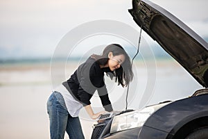 Stressed women after a car breakdown with Red triangle of a car