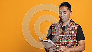 Stressed worker annoyed by paperwork, studio background