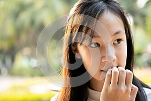 Stressed worried child girl bites finger nails,female people with nail biting,feel anxious,woman with hand on mouth biting her photo