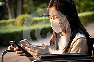 Stressed worried child girl wearing medical face mask,check the amount of dust,search for news from the phone about air pollution,
