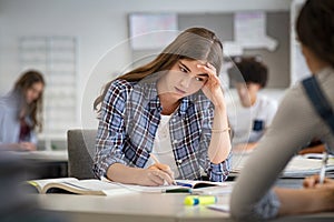 Stressed and worried girl durig exam at school