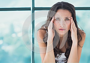 Stressed worried woman against window