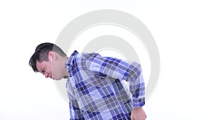 Stressed young Asian hipster man having back pain