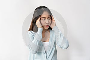 Stressed young Asian woman suffering on depression. Lady suffer from migraine and headache standing over white background. Sad,
