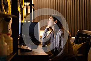 Stressed young Asian woman thinking while working from home