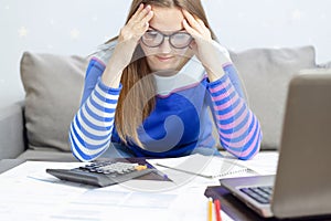 Stressed young brunet woman sits at home manage household finances frustrated with family financial problems. Distressed upset