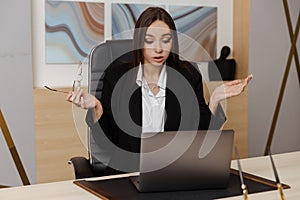 Stressed young business woman annoyed with computer problem, office worker hates stuck laptop