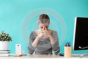 Stressed young business woman suffering anxiety while working in the office