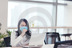 Stressed Young business woman wear face mask and  coughing in office