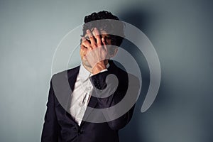 Stressed young businessman with headache