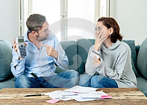 Stressed young couple having an argument over credit car debts payments and home finance