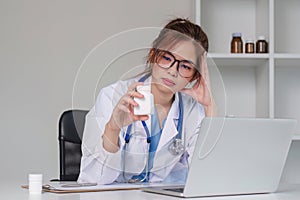 Stressed young female doctor looking at laptop, work related chaos, worried about mistake at work The stressed-out