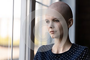 Stressed young female suffering of oncology trying to be strong