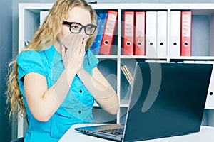 Stressed young girl in front of a computer screen. She accidentally deleted files.