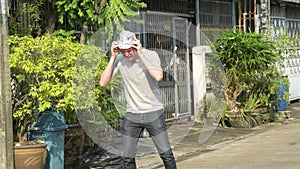 Stressed young man wearing tin foil hat as conspiracy theory concept outdoors