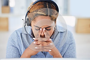 Stressed young mixed race female call centre agent getting a headache while working in office. Consultant making