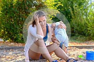 Stressed young mother with a difficult baby boy