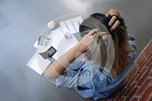 Stressed young woman calculating monthly home expenses with bank account balance and credit card bills