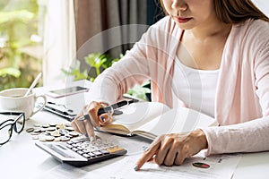 Stressed young woman calculating monthly home expenses, taxes, bank account balance and credit card bills payment