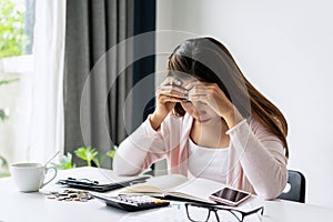 Stressed young woman calculating monthly home expenses, taxes, bank account balance and credit card bills payment