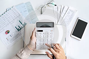 Stressed young woman calculating monthly home expenses, taxes, bank account balance and credit card bills payment