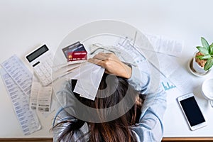 Stressed young woman calculating monthly home expenses, taxes, bank account balance and credit card bills payment