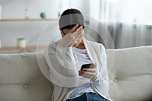 Stressed young woman feeling confused of bad news notification.