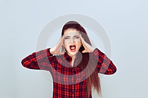 Stressed young woman shouting screaming hands on head. Burnout concept