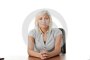 Stressed young woman sitting behind a desk