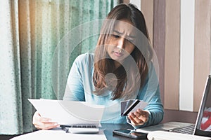 Stressed young woman trying to find money to pay credit card debt