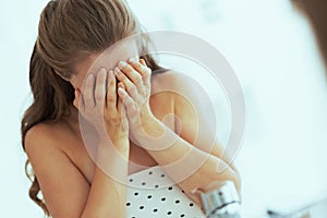 Stressed young woman in white bathroom