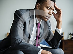A stressful black man sitting photo