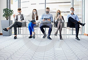 Stressful business people waiting for job interview with face mask, social distancing quarantine during COVID19 affect