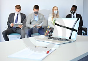 Stressful business people waiting for job interview with face mask, social distancing quarantine during COVID19 affect