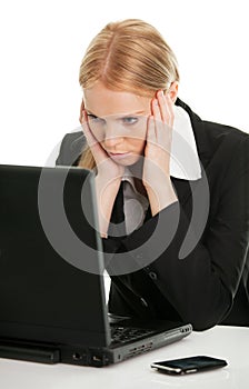 Stressful business woman working on laptop