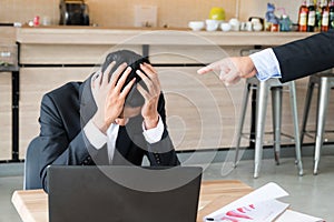 Stressful business man with his hands on his head in front of her laptop, Male colleagues pointing fingers at upset