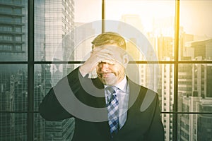 Stressful businessman standing in office