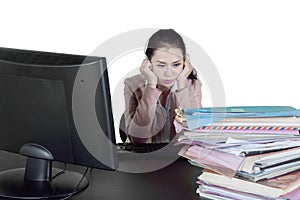 Stressful businesswoman looks at many documents