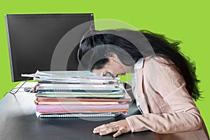 Stressful businesswoman sleeps above documents