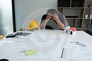 Stressful engineer man put hand on head. exhausted architect is