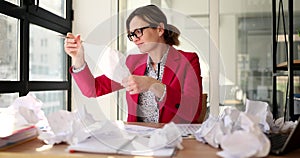 Stressful hysterical woman looks at crumpled paper