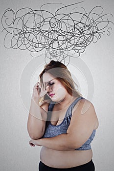 Stressful overweight woman with crumpled sign