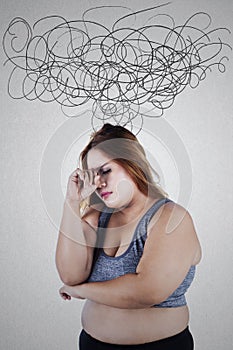 Stressful overweight woman with crumpled sign photo